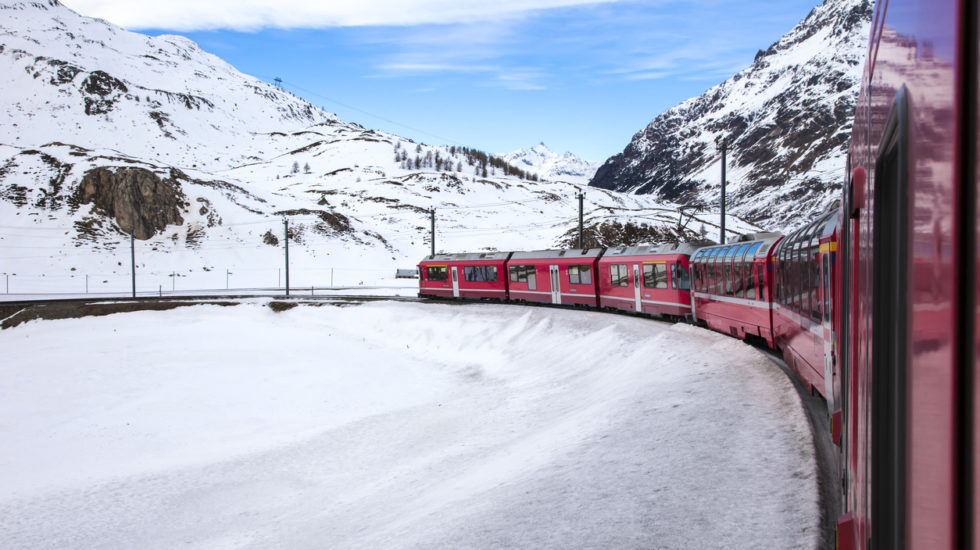 Train Goes Across Snowy Mountain Between Italy And Switzerland